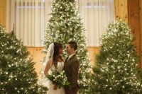 22 a cluster of lit up Christmas trees is an amazing wedding backdrop for a winter or Christmas wedding, what can be better than that