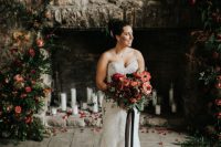 30 a stunning Christmas wedding backdrop – an old stone fireplace with pillar candles, greenery and red bloom arrangements is pure romance