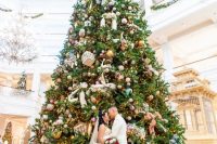 32 an oversized boldly decorated Christmas tree with lots of lights and ornaments is a beautiful and cool idea to rock
