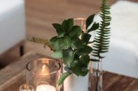 32 modern winter wedding decor of a white and clear vases, some greenery and candles is a lovely idea, and it can be your centerpiece