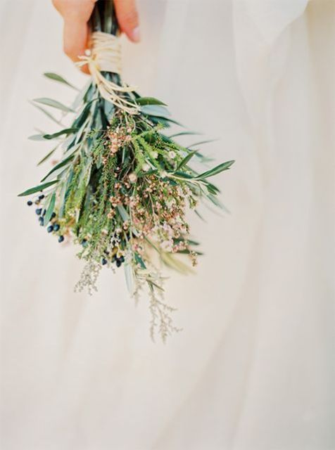 a beautiful and relaxed wedding bouquet of greenery, berries and grasses plus a neutral ribbon bouquet wrap for a boho bride