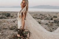 a beautiful blush A-line wedding dress with a train and a super long capelet, with white stars embroidered is a gorgeous idea