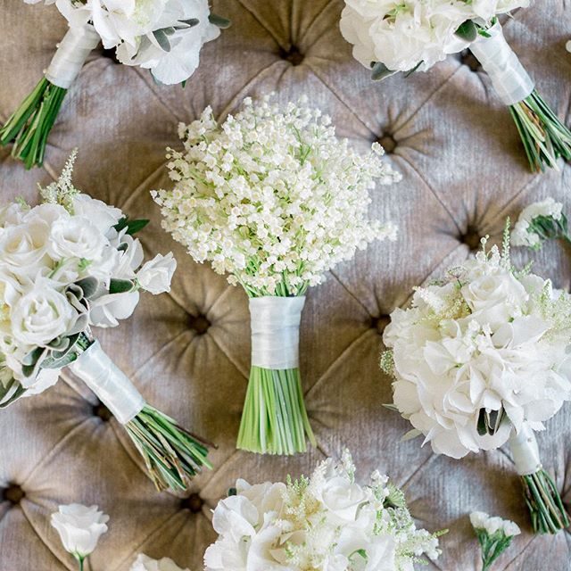 a beautiful small lily of the valley wedding bouquet with a white ribbon wrap is a chic idea for a spring or summer wedding