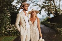 a boho lux bridal look with a fabulous mermaid lace applique wedding dress with a feather train and a creamy hat plus statement earrings