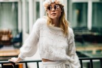 a boho winter bridal look with a cropped patterned sweater, a white high waisted skirt and a neutral floral crown