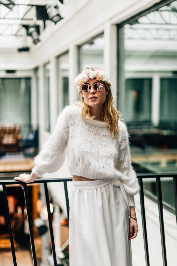 a boho winter bridal look with a cropped patterned sweater, a white high waisted skirt and a neutral floral crown