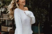 a casual bridal look with an oversized one shoulder sweater and a neutral skirt with a slit plus pearl earrings