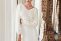 a casual chic bridal look with a white V-neckline sweater, a white pleated midi skirt and blue shoes with bows