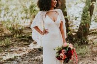 a chic and feminine bridal look with a lace slip wedding dress with a train and a short capelet that accents the deep neckline