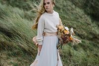 a delicate and casual winter bridal look with a neutral pearly sweater, a neutral A-line maxi skirt and a pink silk sash
