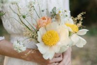 a delicate and chic wedding bouquet composed of Claire de Lune peonies, coral peonies, and white daisies