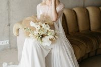 a delicate modern bridal look with a white slip maxi wedding dress, a semi sheer capelet with a train, clear shoes