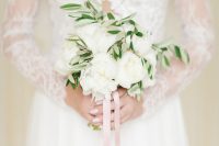 a gorgeous small wedding bouquet of white peonies and greenery plus some pink ribbons is a fantastic idea for a spring or summer wedding