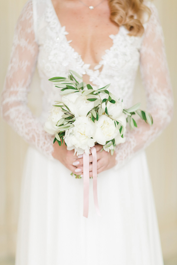 a gorgeous small wedding bouquet of white peonies and greenery plus some pink ribbons is a fantastic idea for a spring or summer wedding