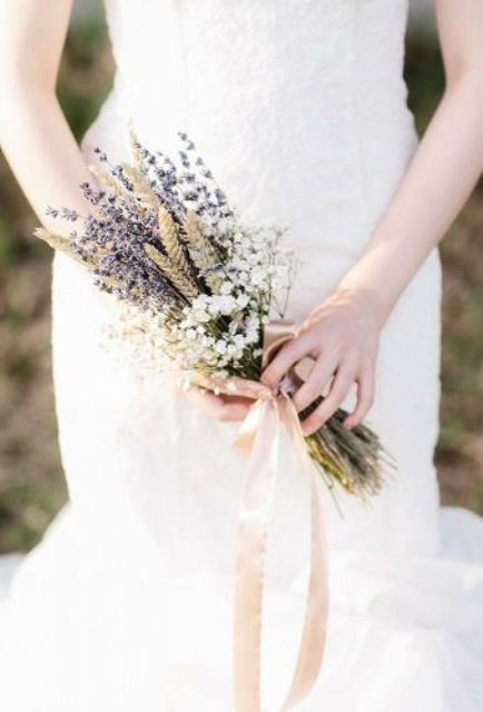 a pretty small wedding bouquet of baby's breath, lavender and wheat plus neutral ribbons is a lovely idea for a boho bride