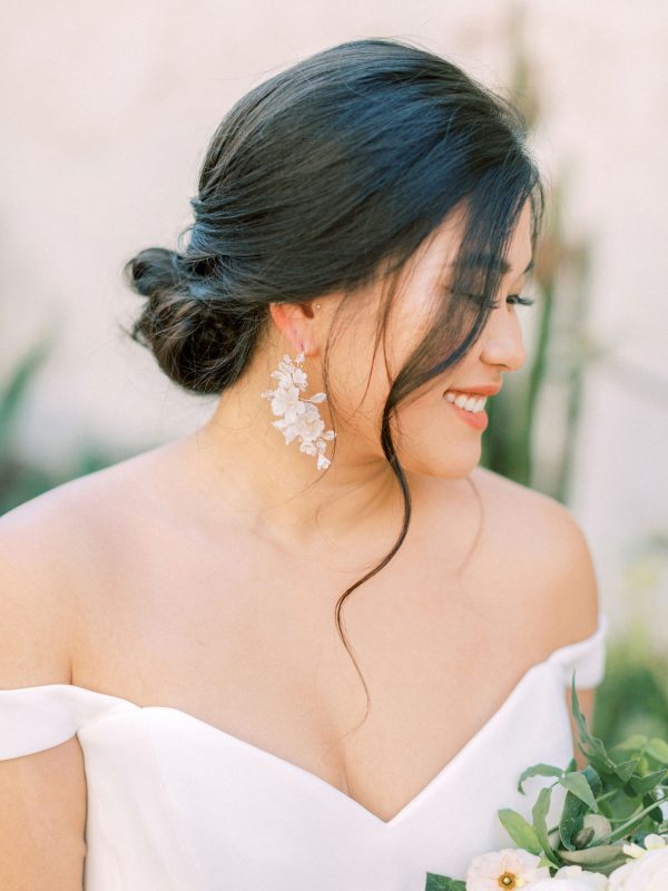 a refined modern bridal look with an off the shoulder plain wedding dress and gorgeous cascading white flower earrings is wow