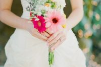 a small and colorful wedding bouquet of pink and hot pink gerberas, greenery, peachy and lilac blooms and a relaxed summer wedding