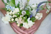 a small and lovely wedding bouquet with white, light blue and purple blooms and greenery is a chic idea for a spring or summer wedding