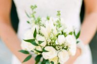 a small and pretty wedding bouquet of white garden roses, waxflower and greenery is a pretty idea for a spring or summer bride