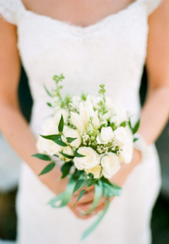 a small and pretty wedding bouquet of white garden roses, waxflower and greenery is a pretty idea for a spring or summer bride