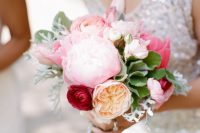 a small bright wedding bouquet pink peonies, red ranunculus, a peony rose and some pale and usual greenery for a summer bride