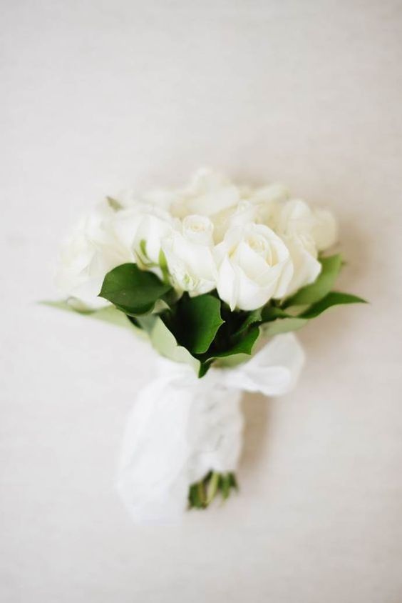 a small white rose and leaf wedding bouquet like this one is timeless classics for every bride and it will fit many bridal outfits