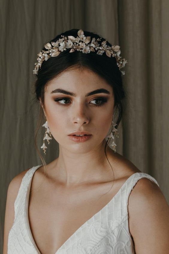 a sophisticated bridal headpiece with leaves and flowers, crystals and pearls and gorgeous matching earrings that show off flowers, too