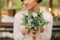 a textural greenery wedding bouquet with dark touches and a twine wrap is great for a rustic or boho bride