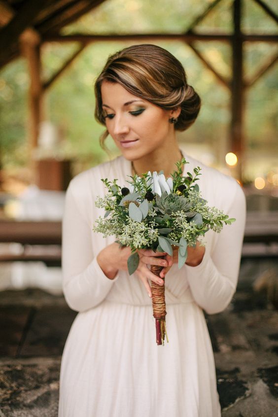 a textural greenery wedding bouquet with dark touches and a twine wrap is great for a rustic or boho bride
