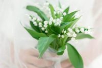 a tiny and gorgeous lily of the valley wedding bouquet with leaves is a fantastic idea for a spring bride, it looks and feels airy