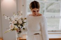 a white sweater with a brown blet and a white tulle skirt are all you need for a delicate casual winter bridal look