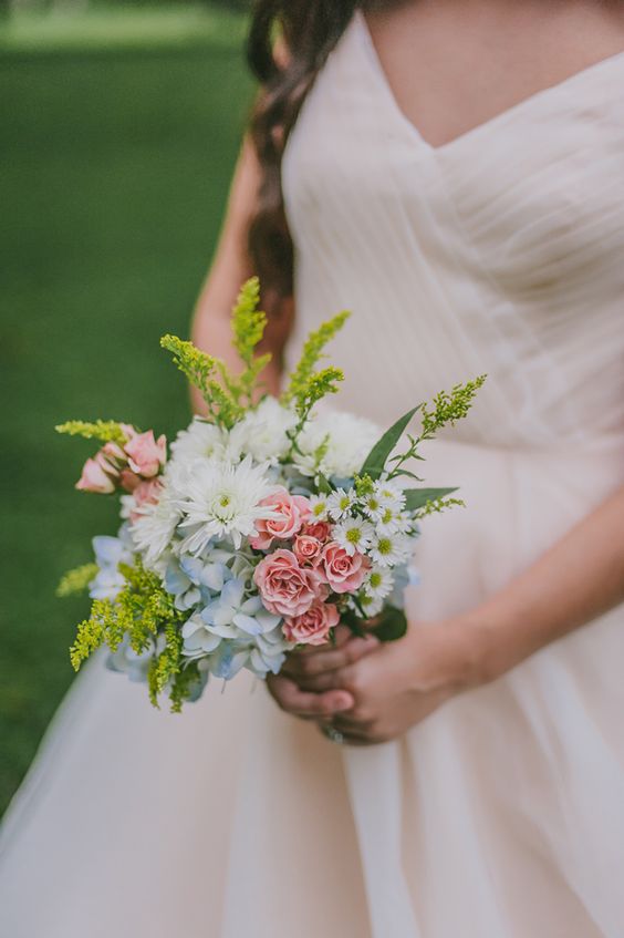 an enchanting wedding bouquet with pale blue and pink and white blooms, bold mimosa touches and leaves is a cool idea for a laid-back wedding