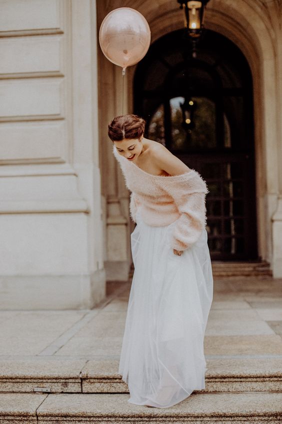 an oversized pink one shoulder sweater and a white tulle skirt plus blush shoes for a girlish and casual winter bridal look