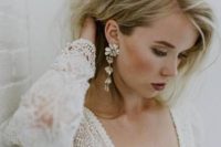 beautiful and super glam cascading flower rhinestone earrings will make your bridal look jaw-dropping and will add a glitzy feel to it