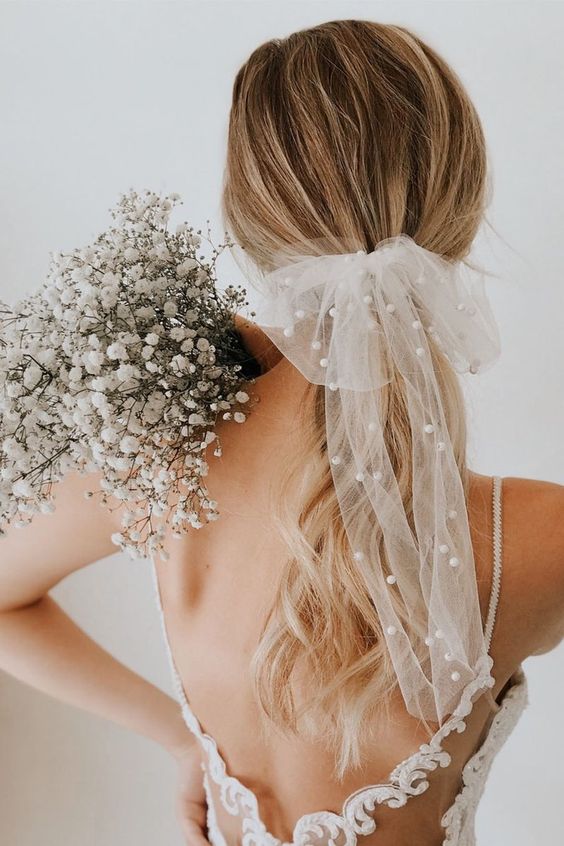 a beautiful sheer bow with pearls is a very trendy bridal accessory and a fresh way to wear pearls on your wedding day