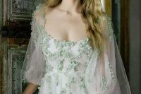 02 a delicate bridal look with an a-line wedding dress with floral applique detailing, semi sheer short sleeves, a square neckline