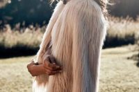 04 a blush fuzzy fur coat over a lace wedding dress to add a bit of edge to a romantic and glam bridal look in fall or winter
