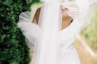 04 a fabulous off the shoulder wedding dress wiht a tulle ruffle neckline and an oversized tulel bow that matches and adds a girlish feel to the look