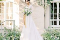 05 a Bridgerton-inspired bridal look with an A-line wedding dress with semi sheer sleeves, a square neckline and a skirt with a train