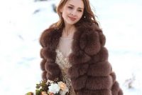 05 a glam gold embellished wedding dress paired with a brown faux fur jacket with short sleeves for a super glam winter bridal look