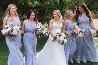 05 periwinkle maxi draped bridesmaid dresses with draped bodices, thick straps and layered skirts for a spring or summer wedding