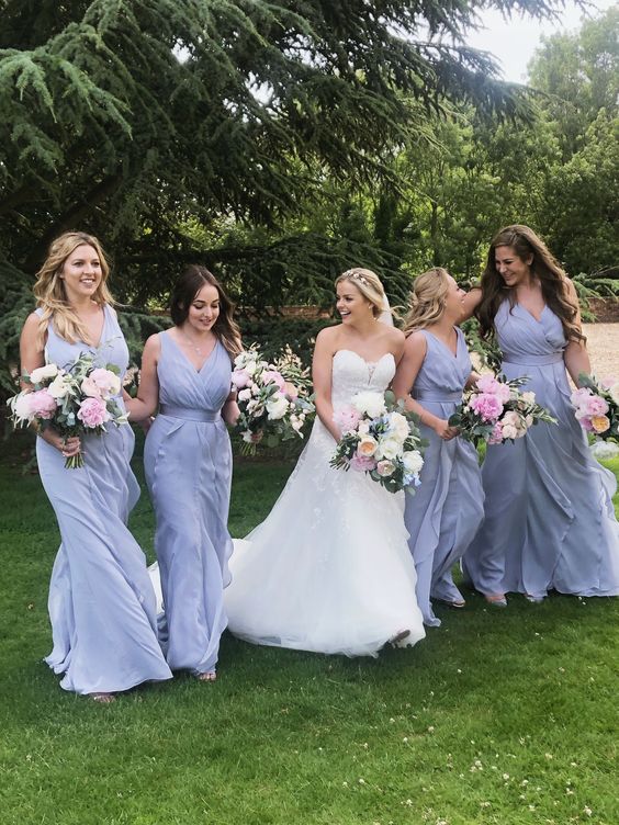 periwinkle maxi draped bridesmaid dresses with draped bodices, thick straps and layered skirts for a spring or summer wedding