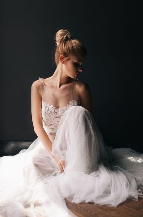 a sleeveless illusion bodice A-line wedding dress with a layered tulle skirt is gorgeous and chic
