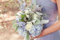 06 a strapless periwinkle maxi bridesmaid dress with a draped bodice, a neutral and periwinkle wedding bouquet with thistles and greenery