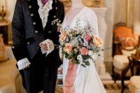 06 gorgeous themed couple’s looks – a glam take on a morning suit for the groom and a beautiful A-line wedding dress with a lace bodice and a train for the bride