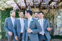 07 a groom and groomsmen wearing grey pants, blue blazers, very peri ties for a delicate and catchy touch of color