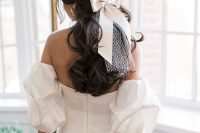 07 a lovely off the shoulder wedding dress with puff sleeves, an open back and a half updo with a braid accented with a bow with a veil for a wow look