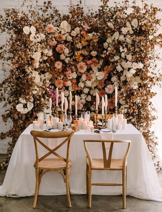 a fantastic earthy-tone flower wall with dried leaves is a gorgeous idea for an elegant fall wedding, it can be used as a ceremony backdrop and a reception backdrop