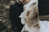08 a large and rough faux fur cover up for a Game of Thrones inspired wedding is a bold statement to rock