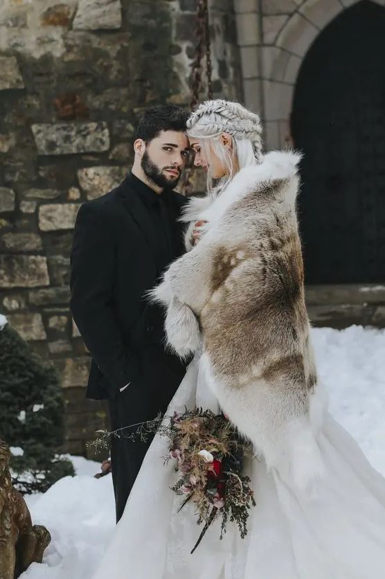 a large and rough faux fur cover up for a Game of Thrones inspired wedding is a bold statement to rock